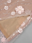 Decorative fabric with floral and bead embellishments on a gray background