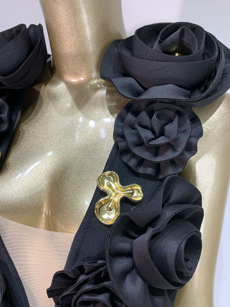 Black floral headband with a gold buckle on a white background