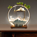Decorative lamp with mountain and deer design on a wooden base