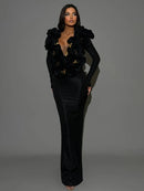 Woman wearing a black floral embellished outfit on a gray background