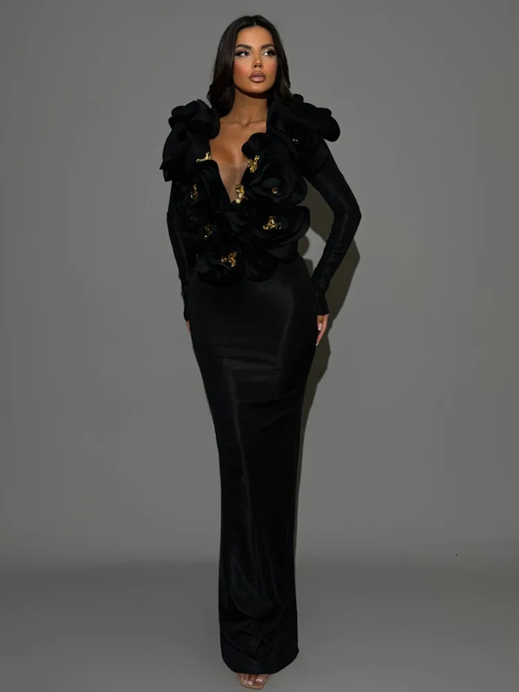 Woman wearing a black floral embellished outfit on a gray background