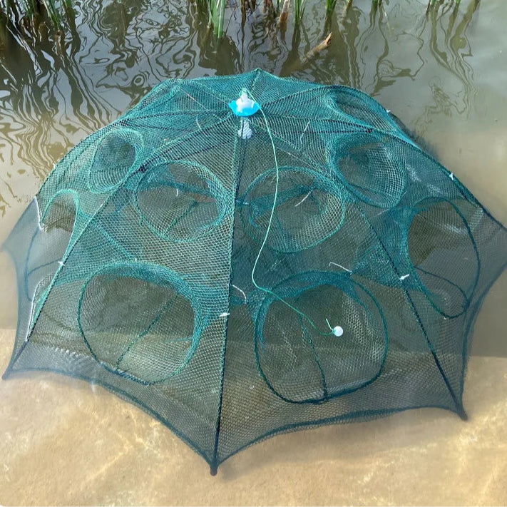Green fishing net on a sandy surface with water in the background