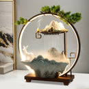 Decorative lamp with mountain and deer design on a stand