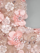 Decorative fabric with pink flowers, pearls, and crystals on a gray background