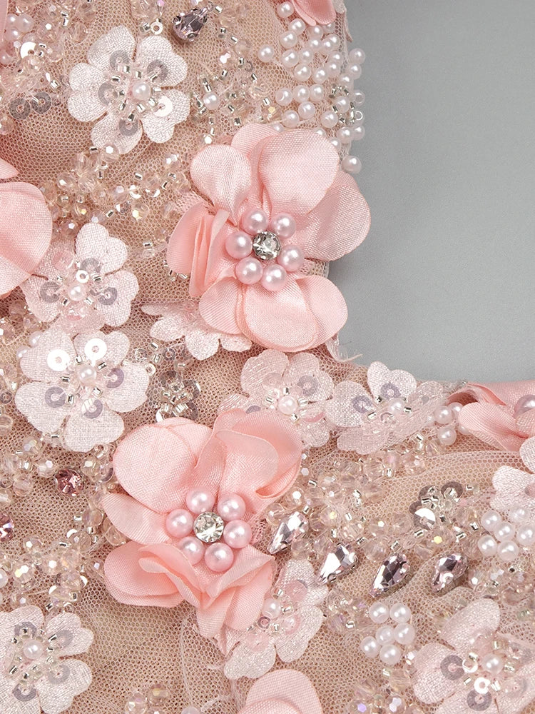 Decorative fabric with pink flowers, pearls, and crystals on a gray background