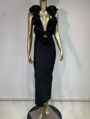 Black evening gown with floral details on a mannequin against a white background
