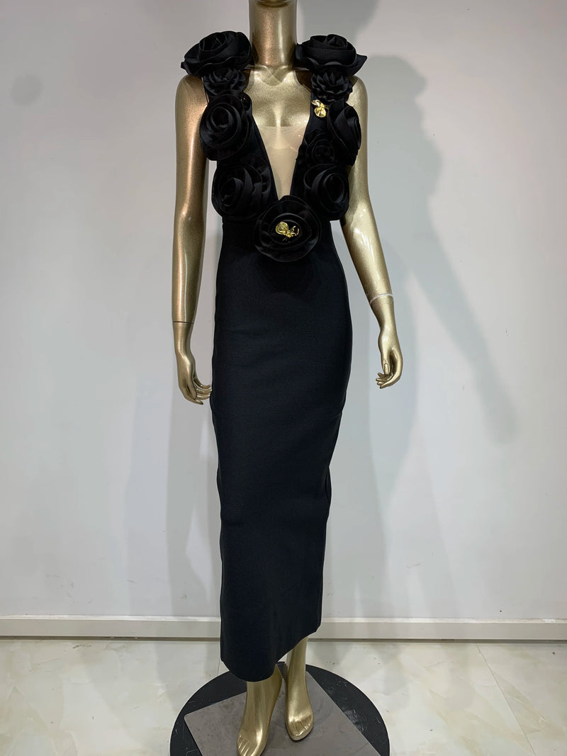 Black evening gown with floral details on a mannequin against a white background